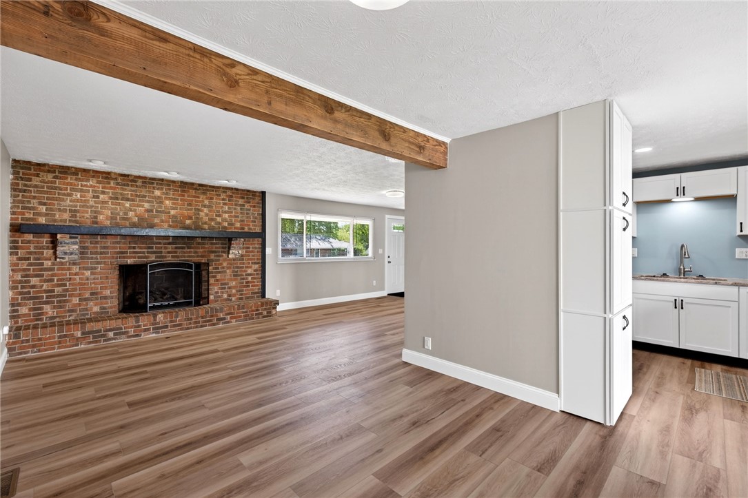 5975 Rosalie Road Dayton, OH 45424 - Photo 8 of 48 This inviting space features a brick fireplace, durable flooring, and a modern kitchen with ample storage.