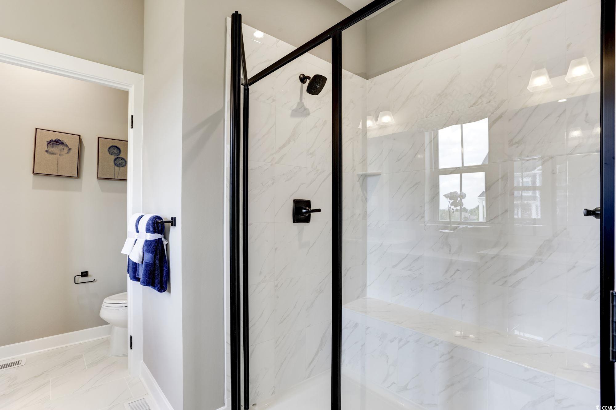 2352 Hazel Way Longs, SC 29568 - Photo 11 of 14 Bathroom featuring a marble finish shower and marble look tiles