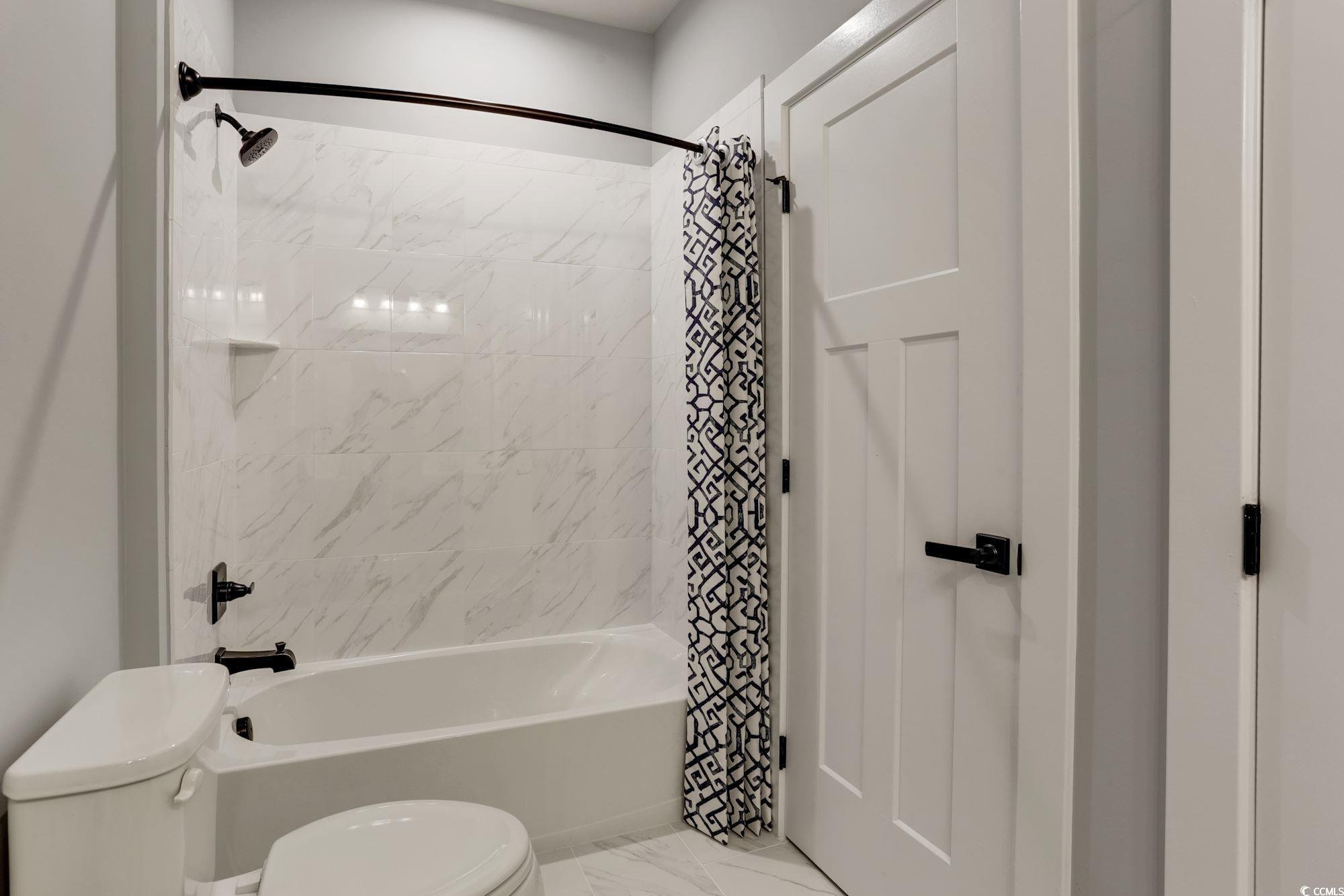 2352 Hazel Way Longs, SC 29568 - Photo 7 of 14 Full bathroom featuring shower / bath combo and marble look tiles