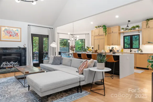 a living room with furniture large window and a fireplace