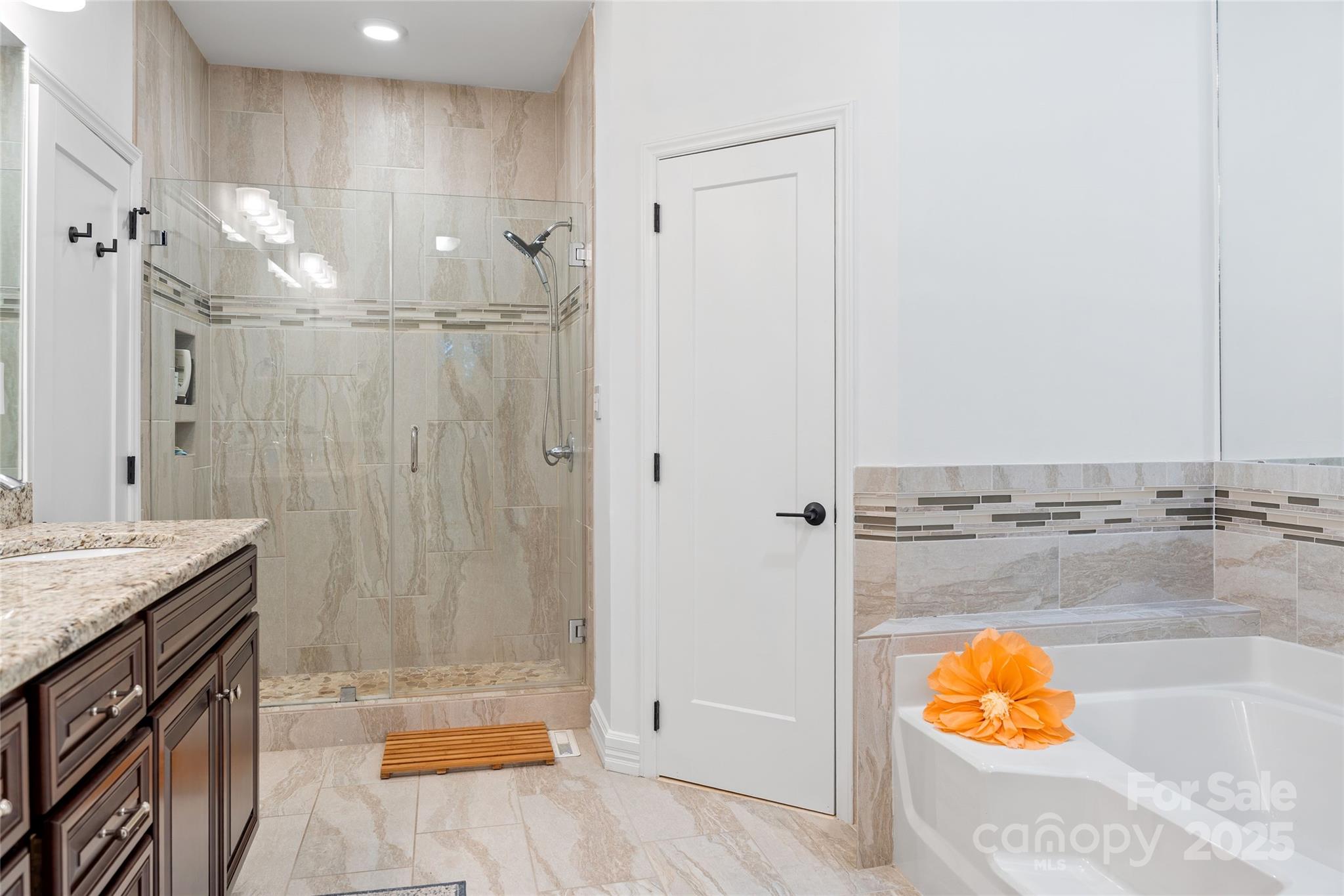 5123 Randolph Road Charlotte, NC 28211 - Photo 12 of 30 a bathroom with a granite countertop sink a mirror and shower
