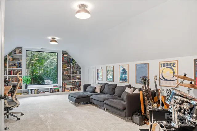 a living room with furniture and a book shelf