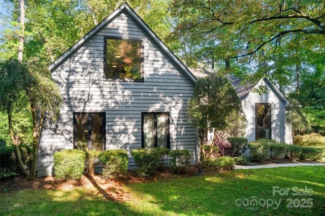 a view of a house with a tree and plants