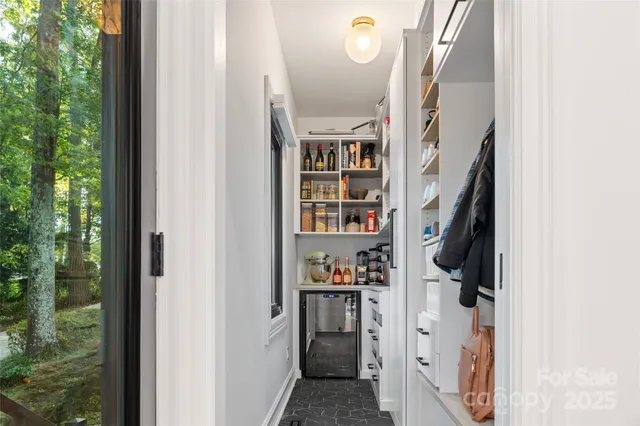 a living room with furniture a large window and a fireplace