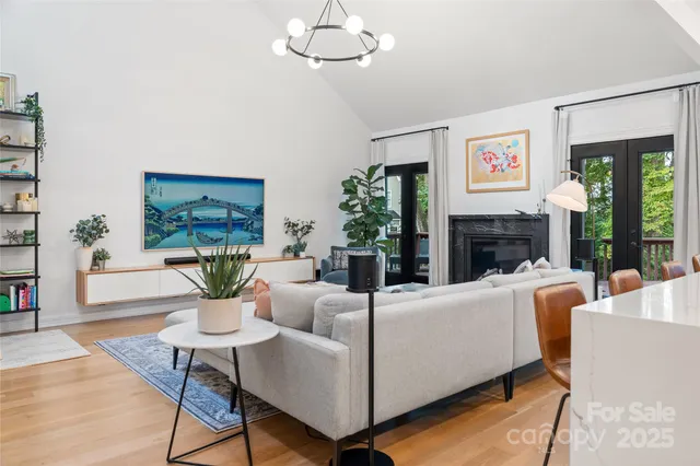 a living room with furniture a large window and a fireplace