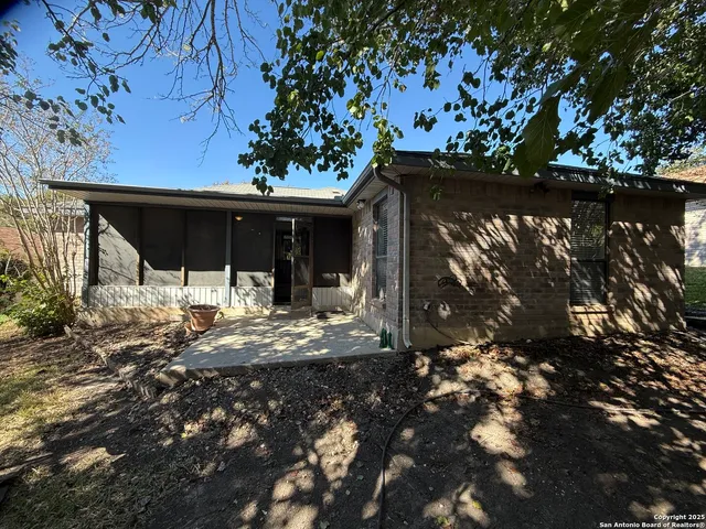a view of a house with a tree in the yard