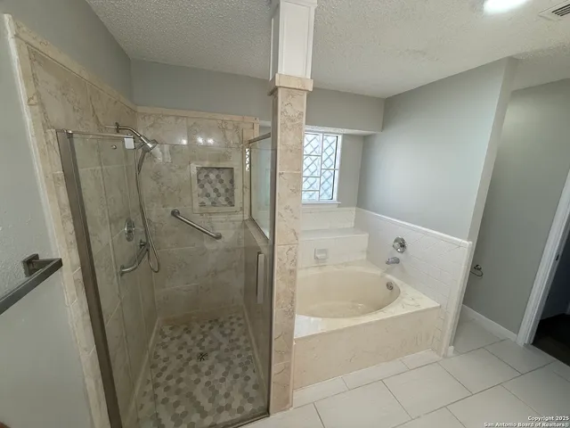 a bathroom with a bathtub and shower