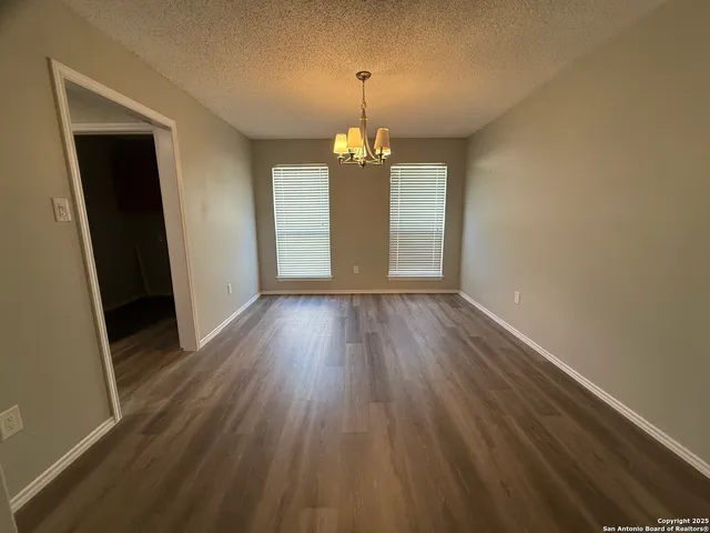 a view of a room with wooden floor and window