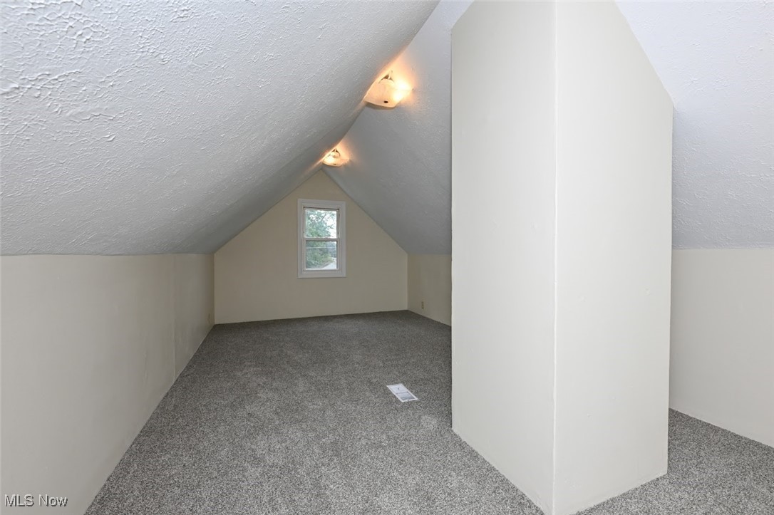 897 Reed Avenue Akron, OH 44306 - Photo 23 of 33 Bonus room featuring carpet, a textured ceiling, and vaulted ceiling