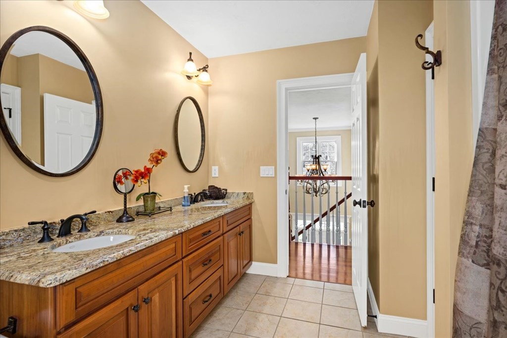 9 Laurel Ridge Lane Shrewsbury, MA 01545 - Photo 28 of 41 a bathroom with a double vanity sink and a mirror