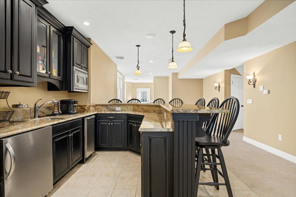 9 Laurel Ridge Lane Shrewsbury, MA 01545 - Photo 29 of 41 a kitchen with stainless steel appliances granite countertop a sink a stove top oven a counter space and cabinets