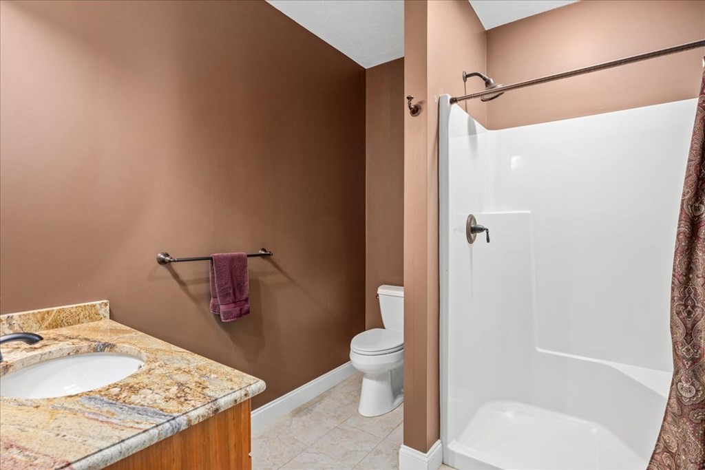 9 Laurel Ridge Lane Shrewsbury, MA 01545 - Photo 33 of 41 a bathroom with a granite countertop sink toilet and shower