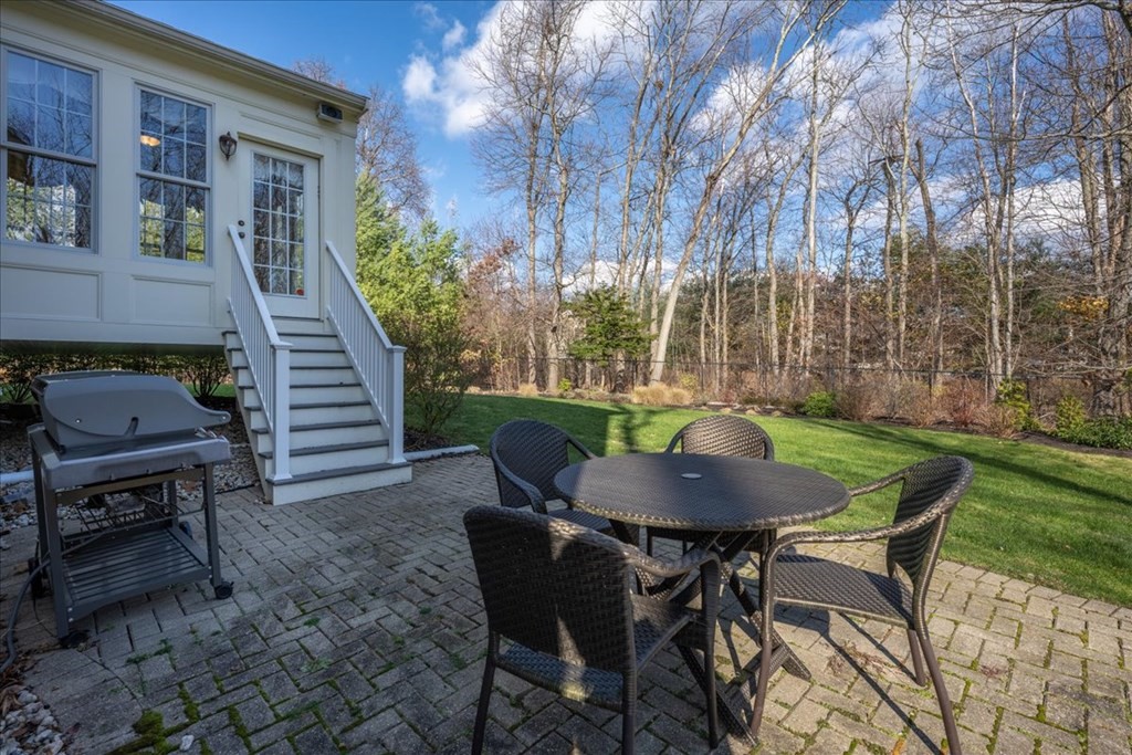 9 Laurel Ridge Lane Shrewsbury, MA 01545 - Photo 34 of 41 a backyard of a house with table and chairs