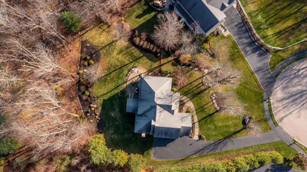 9 Laurel Ridge Lane Shrewsbury, MA 01545 - Photo 38 of 41 a backyard of a house with lots of tress