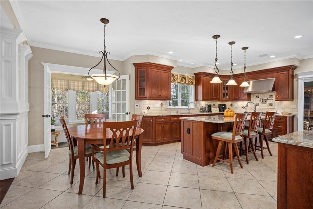 9 Laurel Ridge Lane Shrewsbury, MA 01545 - Photo 7 of 41 a kitchen with a dining table chairs and white cabinets