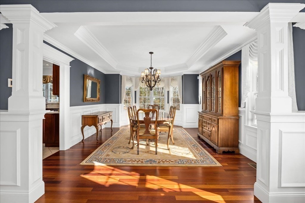 9 Laurel Ridge Lane Shrewsbury, MA 01545 - Photo 8 of 41 a dining room with wooden floor a chandelier a wooden table and chairs