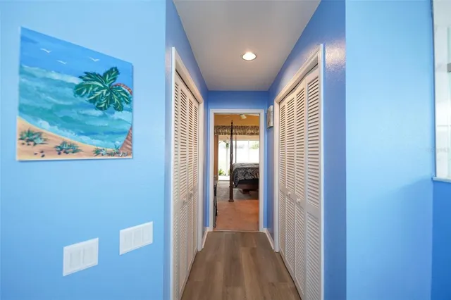 a view of a hallway with wooden floor