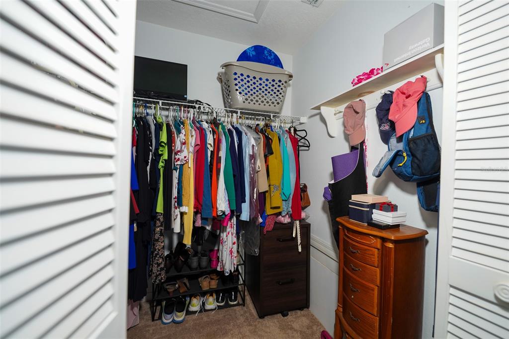 7340 Flyway Drive Spring Hill, FL 34607 - Photo 20 of 32 a view of walk in closet with clothes and shoes