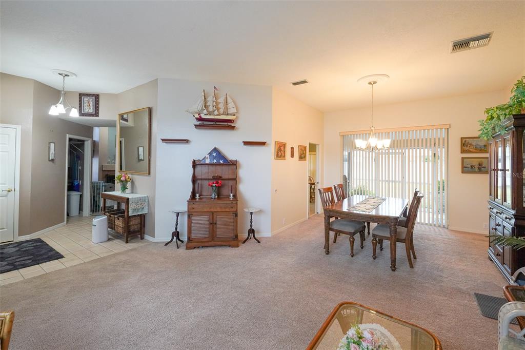 7340 Flyway Drive Spring Hill, FL 34607 - Photo 2 of 32 a dining room with furniture and a view of bedroom