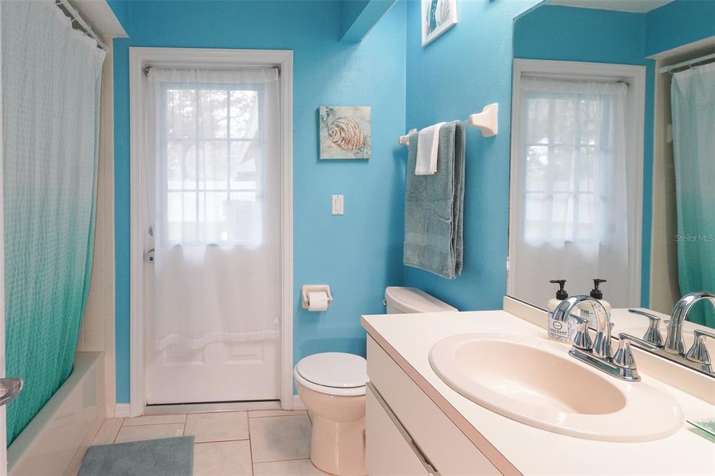 7340 Flyway Drive Spring Hill, FL 34607 - Photo 23 of 32 a bathroom with a sink a toilet and shower