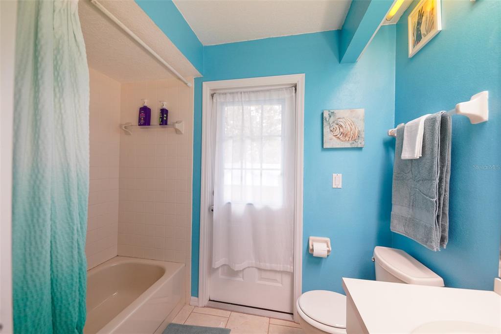 7340 Flyway Drive Spring Hill, FL 34607 - Photo 24 of 32 a bathroom with a toilet and shower