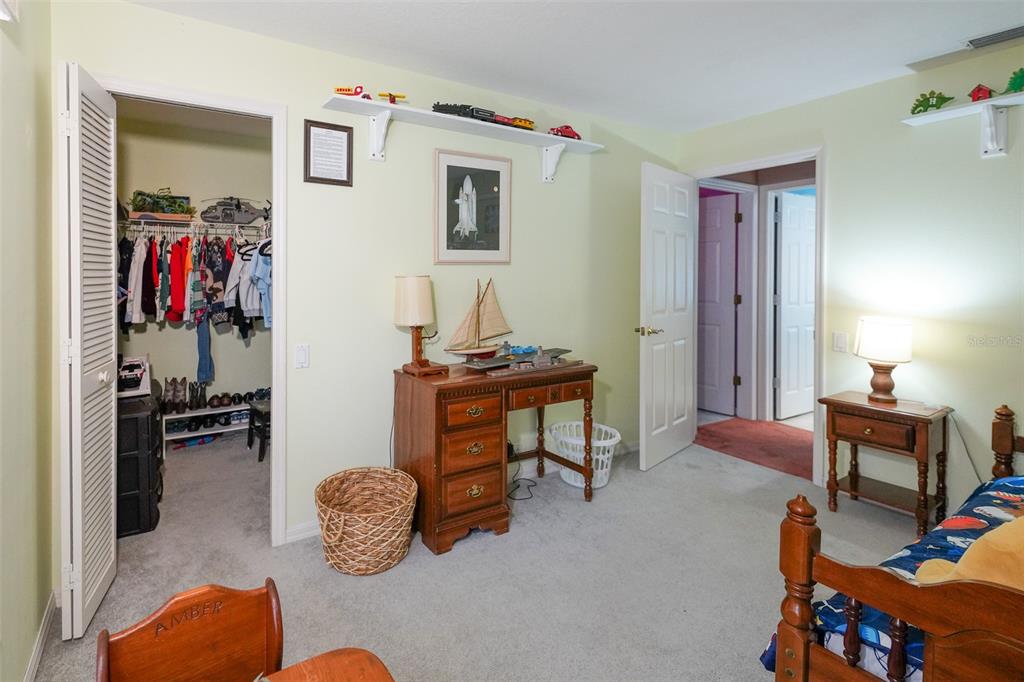 7340 Flyway Drive Spring Hill, FL 34607 - Photo 26 of 32 a bedroom with furniture and a window