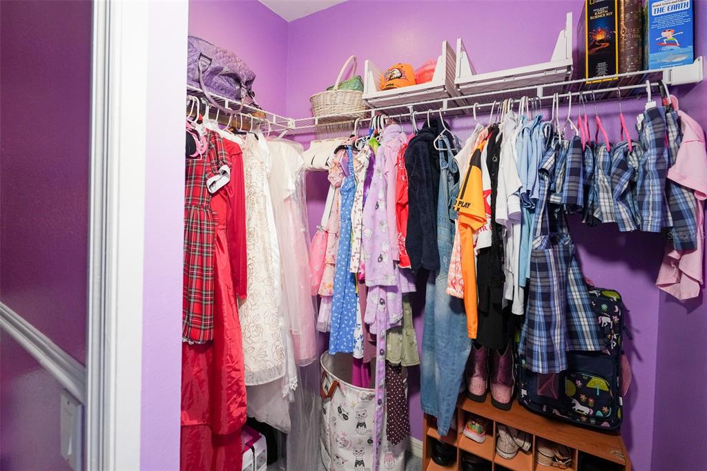 7340 Flyway Drive Spring Hill, FL 34607 - Photo 27 of 32 a view of walk in closet with clothes