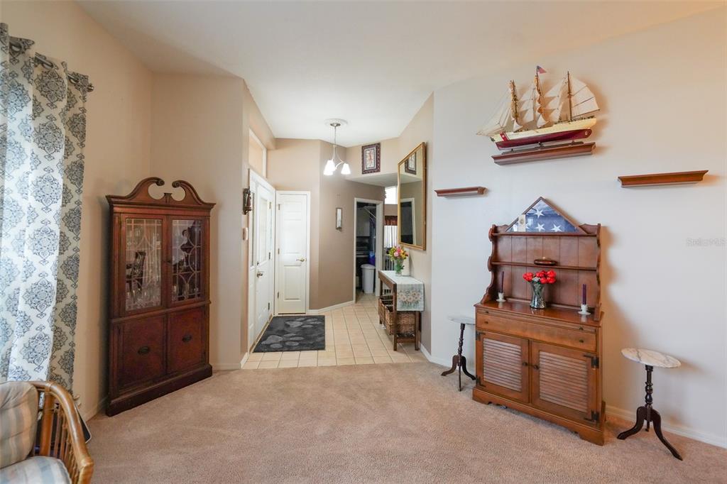 7340 Flyway Drive Spring Hill, FL 34607 - Photo 3 of 32 a living room with furniture and a flat screen tv