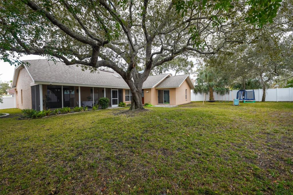7340 Flyway Drive Spring Hill, FL 34607 - Photo 32 of 32 a front view of a house with a garden