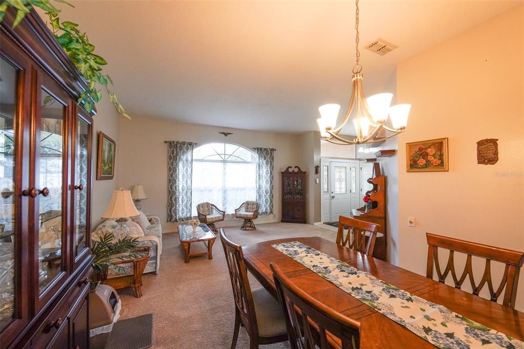 7340 Flyway Drive Spring Hill, FL 34607 - Photo 5 of 32 a view of a dining room with furniture window and outside view