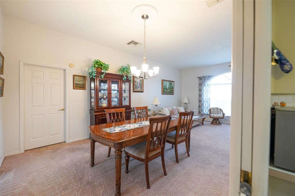 7340 Flyway Drive Spring Hill, FL 34607 - Photo 6 of 32 a view of a dining room with furniture and window