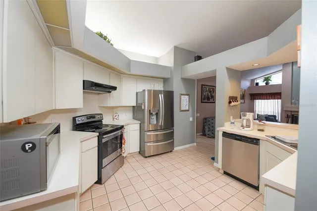 a kitchen with a sink cabinets and stainless steel appliances