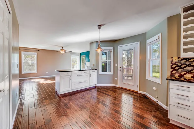 a open kitchen with window and wooden floor