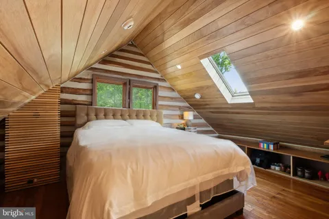 a bed sitting in a bedroom next to a balcony