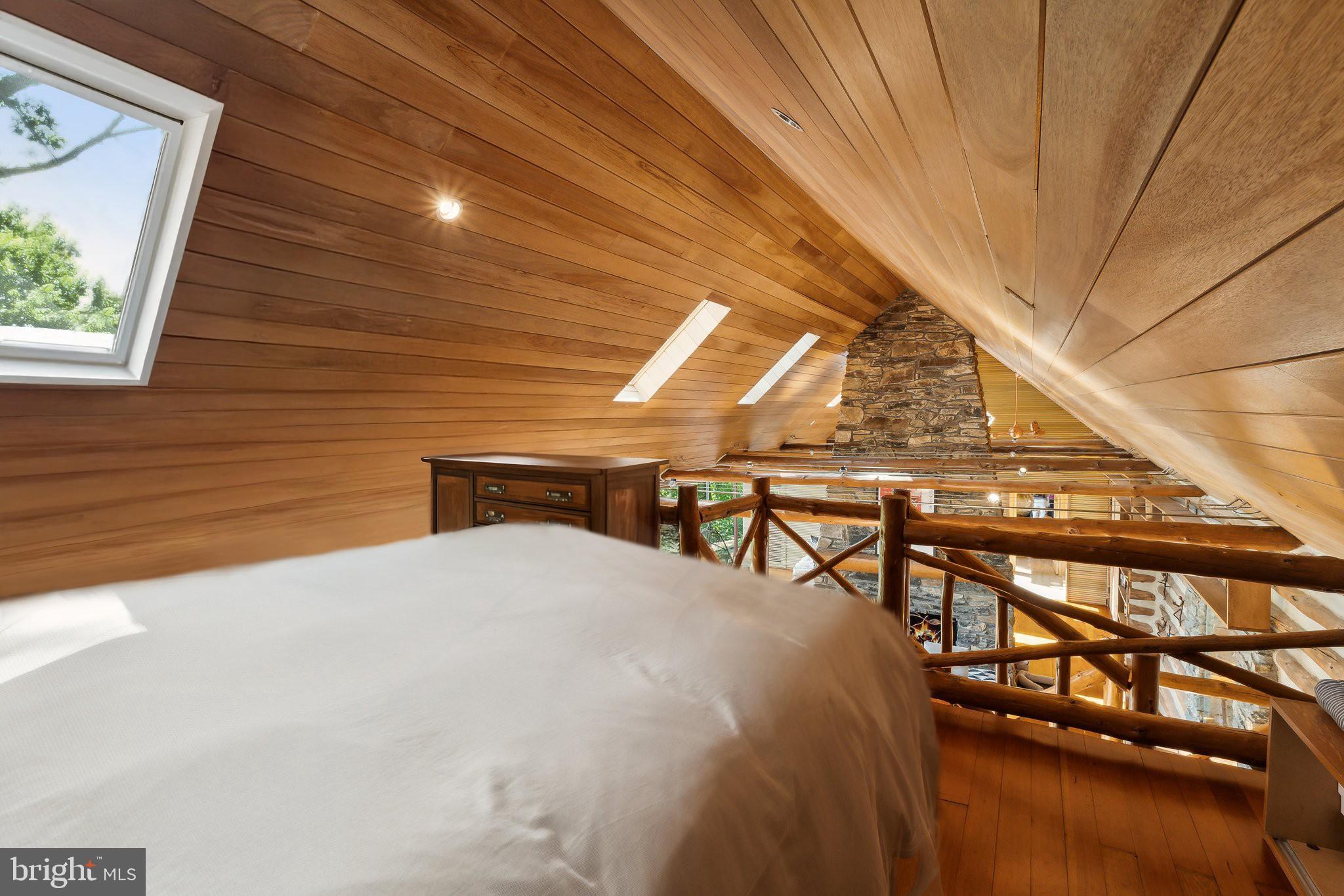 11540 Springridge Road Potomac, MD 20854 - Photo 18 of 35 a bedroom with a bed and a chandelier