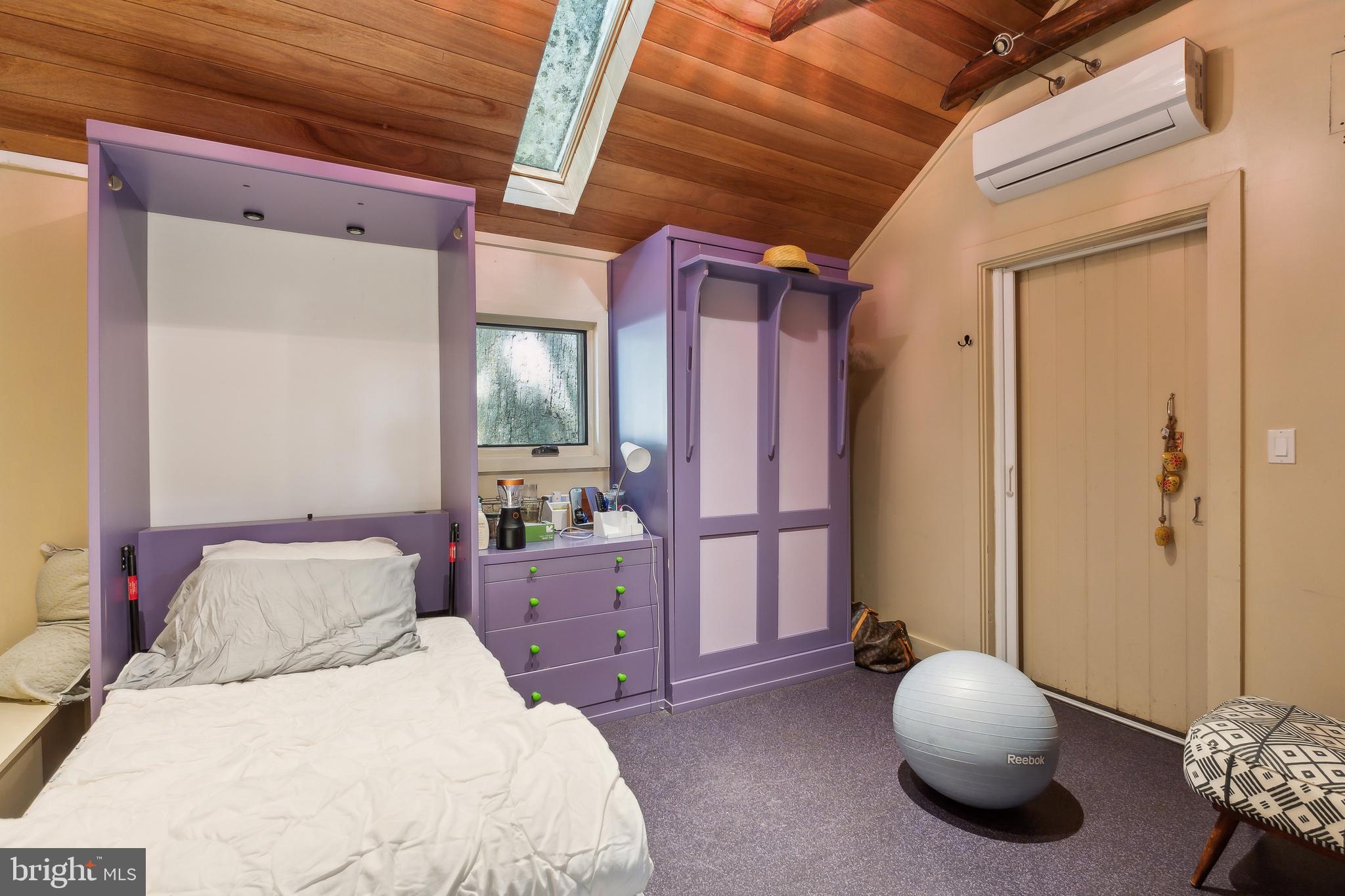 11540 Springridge Road Potomac, MD 20854 - Photo 23 of 35 a bedroom with a bed and a chandelier