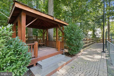 a patio with wooden fence and plants