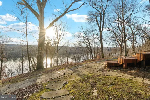 a backyard of a house with barbeque oven and outdoor seating