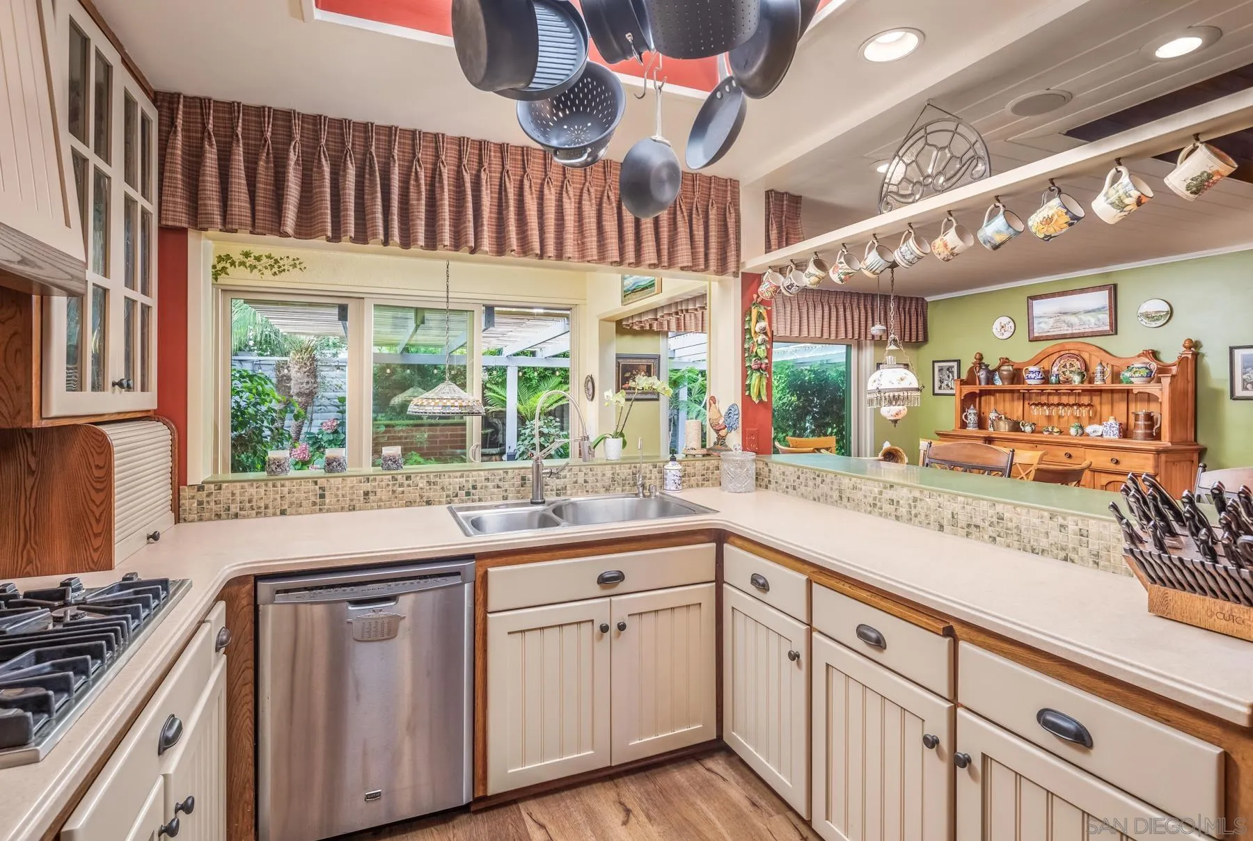 5118 Shore Drive Carlsbad, CA 92008 - Photo 12 of 21 a kitchen with stainless steel appliances a sink and cabinets