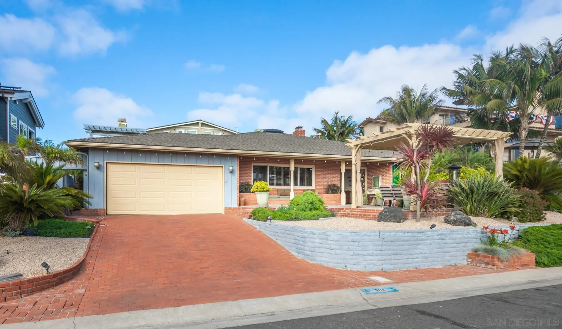 5118 Shore Drive Carlsbad, CA 92008 - Photo 2 of 21 a front view of a house with a yard and potted plants