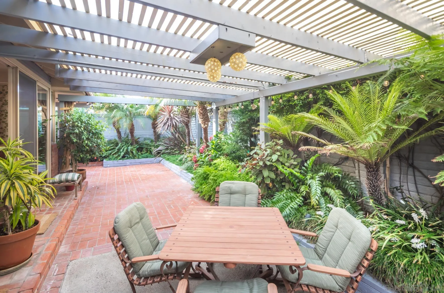 5118 Shore Drive Carlsbad, CA 92008 - Photo 7 of 21 a patio with a table and chairs with potted plants