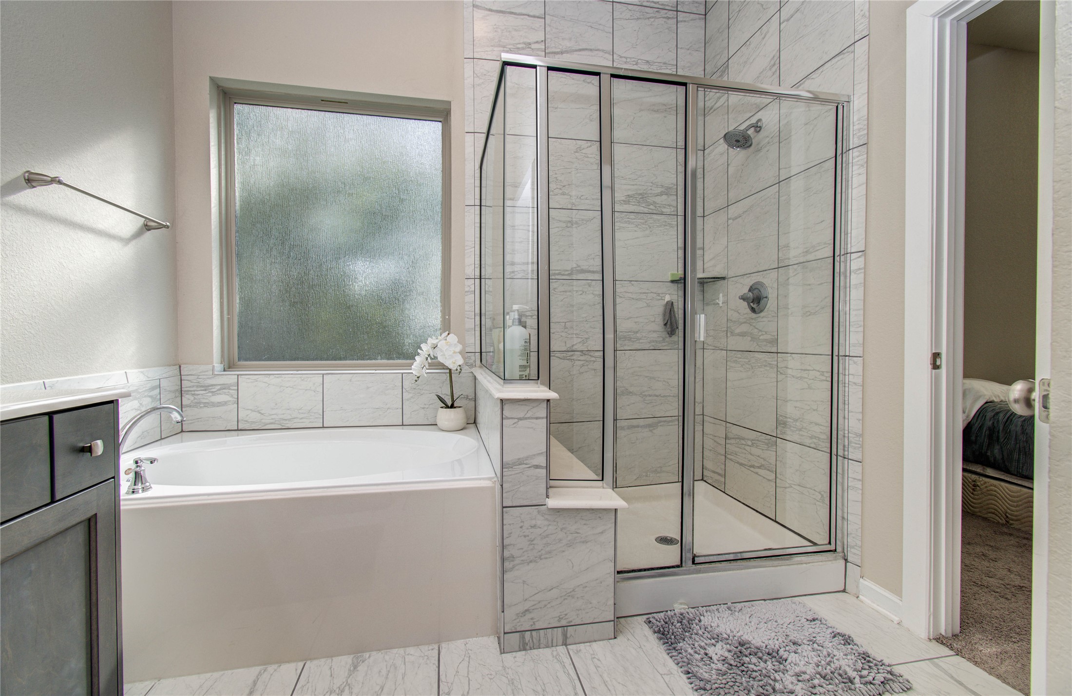 22290 Rustling Cone Court Porter, TX 77365 - Photo 18 of 30 a bathroom with a bathtub and a shower