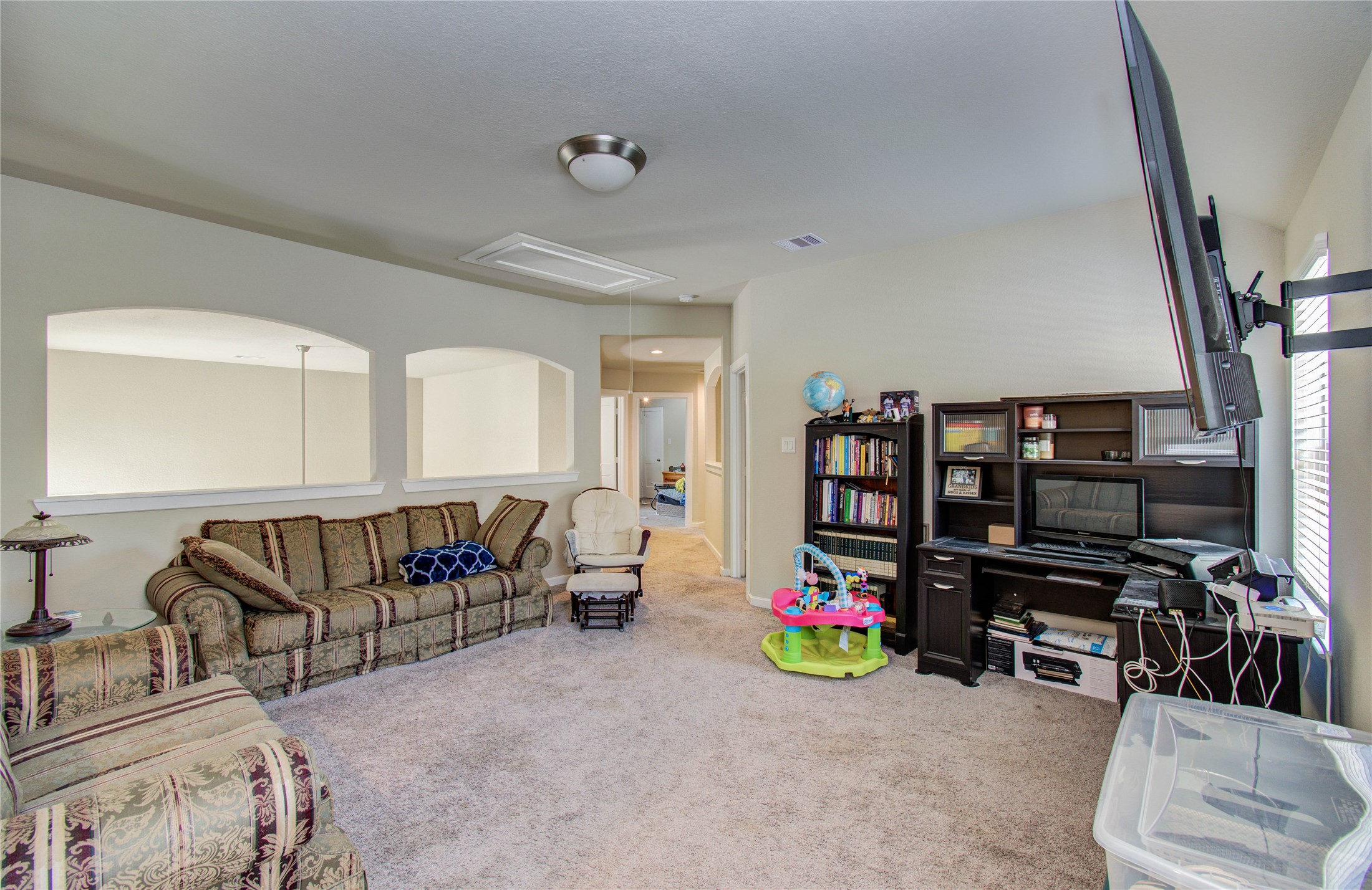 22290 Rustling Cone Court Porter, TX 77365 - Photo 20 of 30 a living room with lots of furniture and a flat screen tv