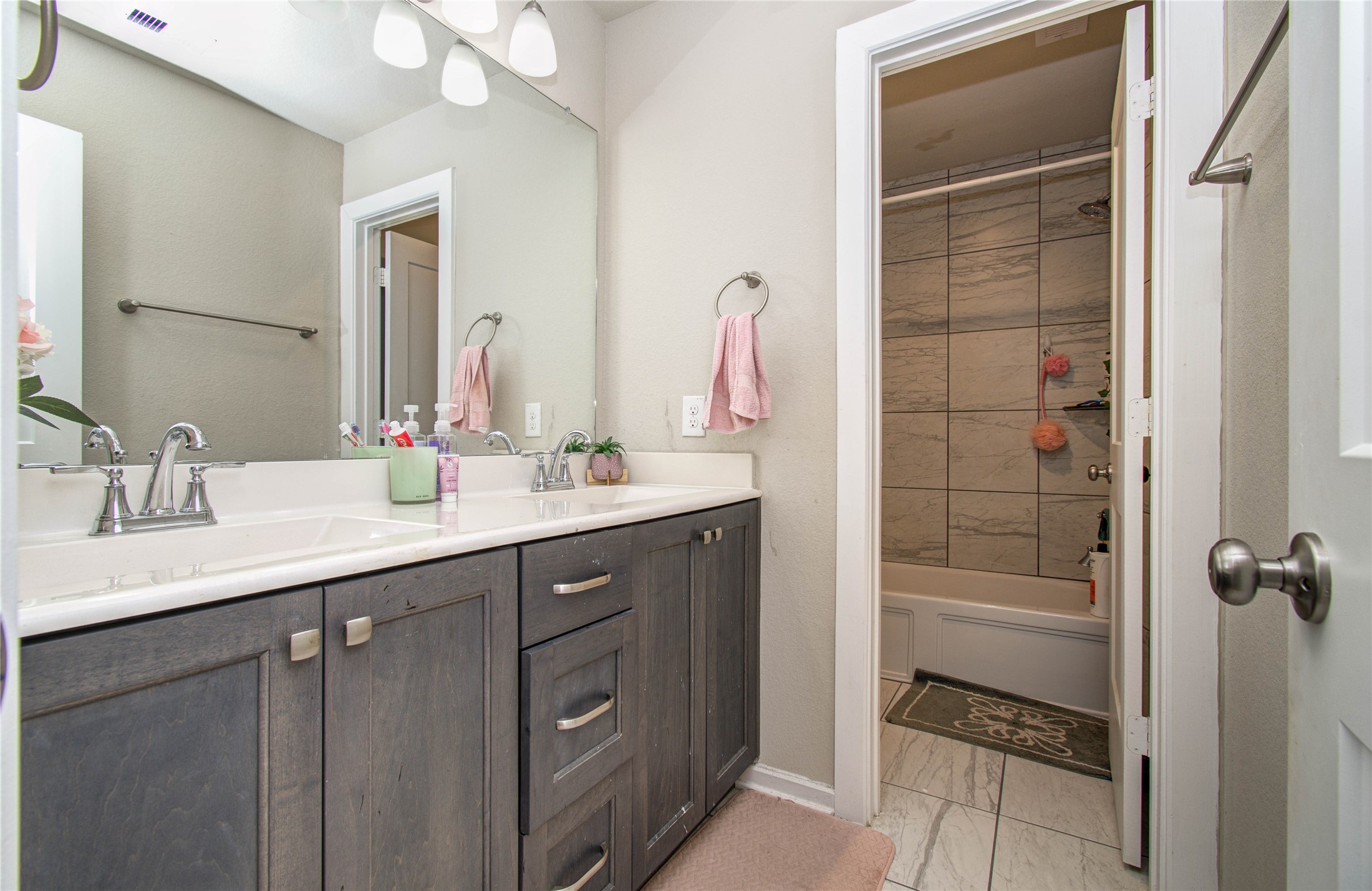 22290 Rustling Cone Court Porter, TX 77365 - Photo 22 of 30 a bathroom with a double vanity sink a toilet and shower
