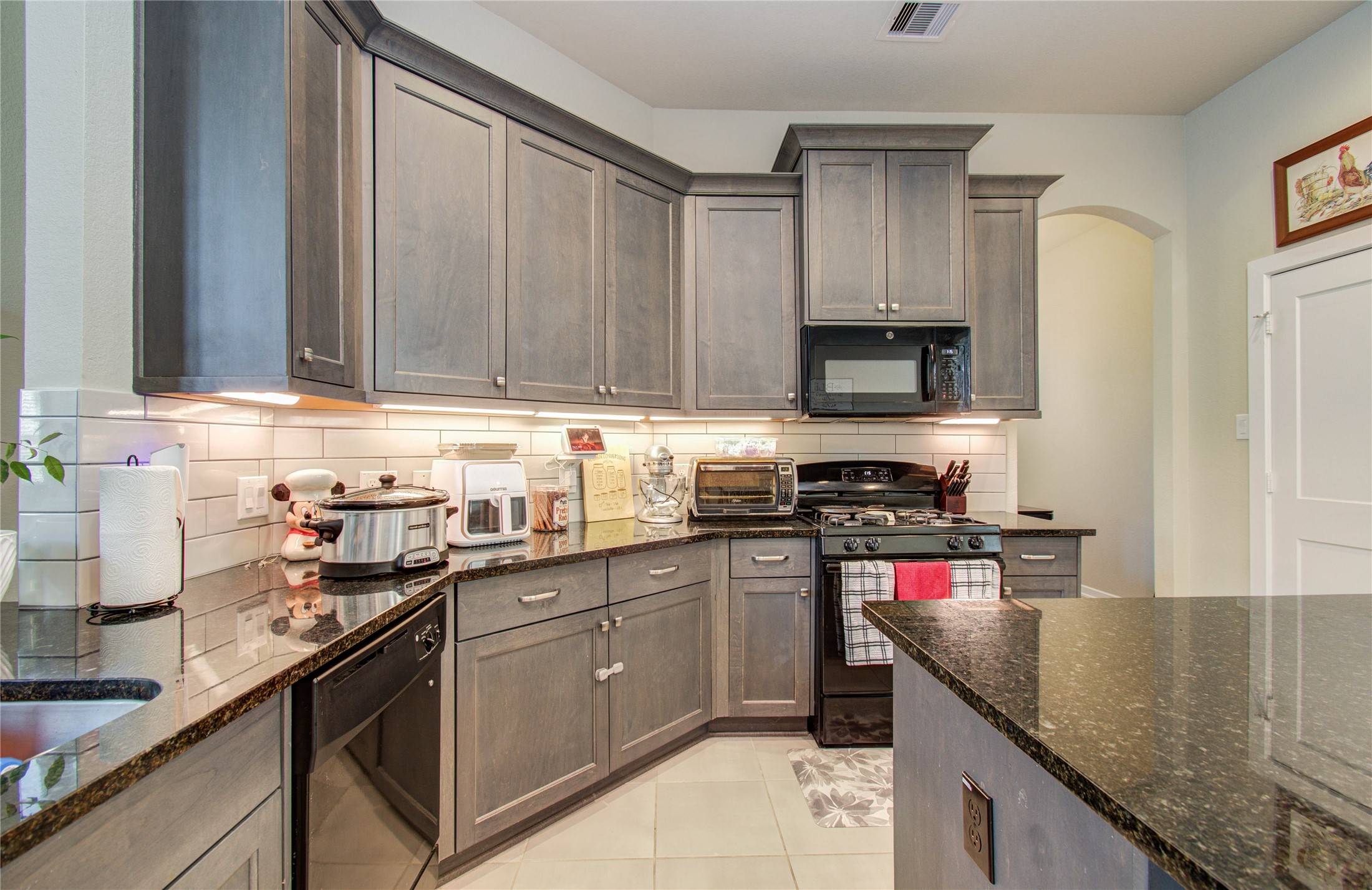 22290 Rustling Cone Court Porter, TX 77365 - Photo 7 of 30 a kitchen with stainless steel appliances granite countertop a sink stove and refrigerator