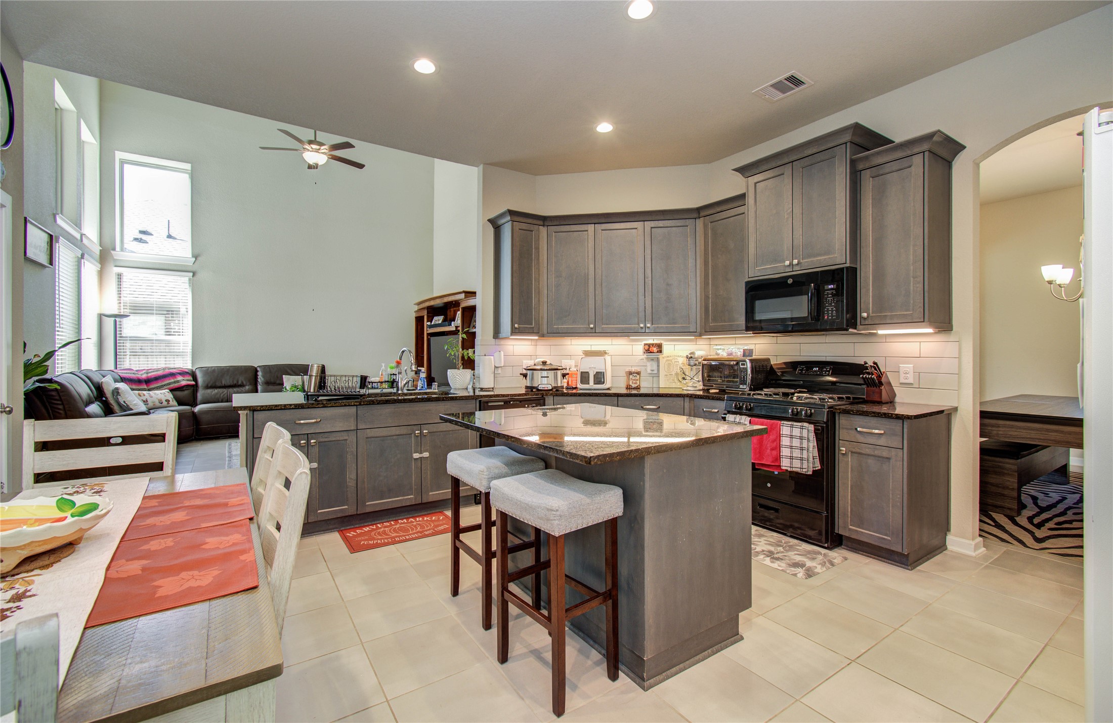 22290 Rustling Cone Court Porter, TX 77365 - Photo 9 of 30 a kitchen with stainless steel appliances granite countertop a stove top oven a sink dishwasher and cabinets