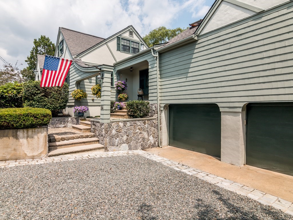 64 Grapevine Road Gloucester, MA 01930 - Photo 3 of 26 a front view of a house with a yard and garage
