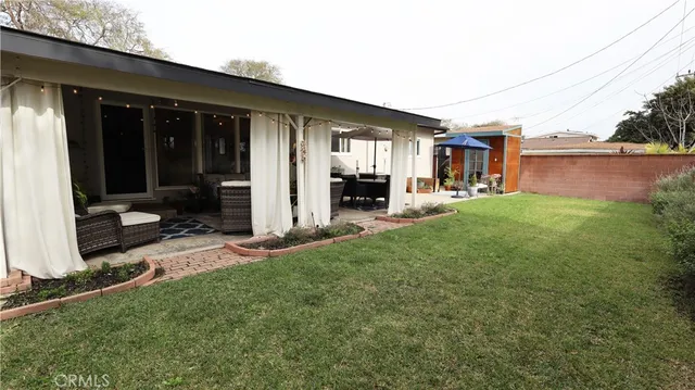 a view of a house with backyard porch and sitting area