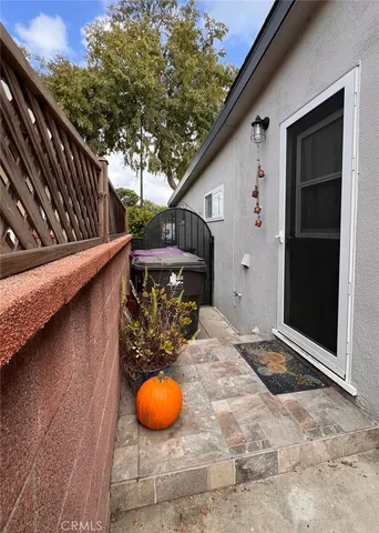 a view of a backyard with chairs and wooden fence