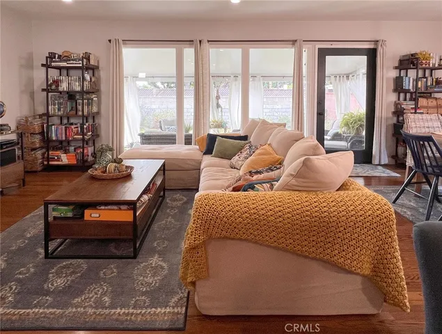 a bedroom with furniture and large window